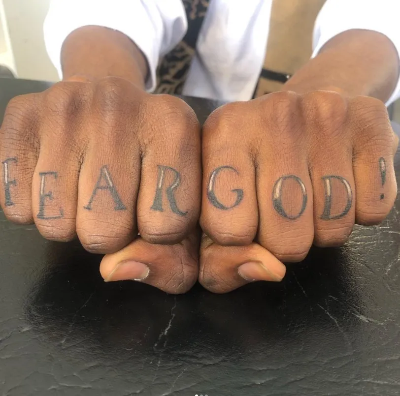 fear god tattoo on fingers