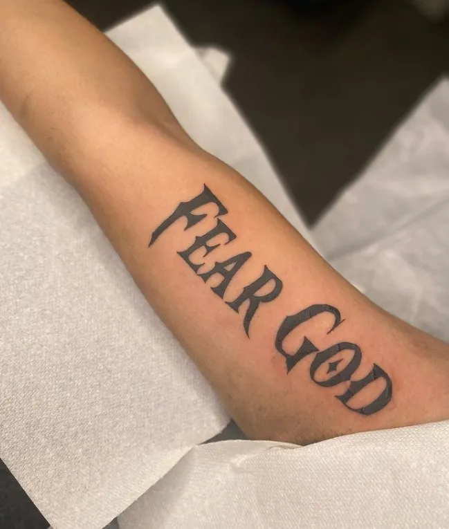 black inked fear god tattoo