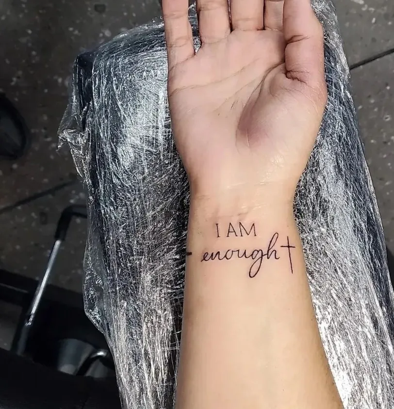 i am enough script tattoo design on wrist