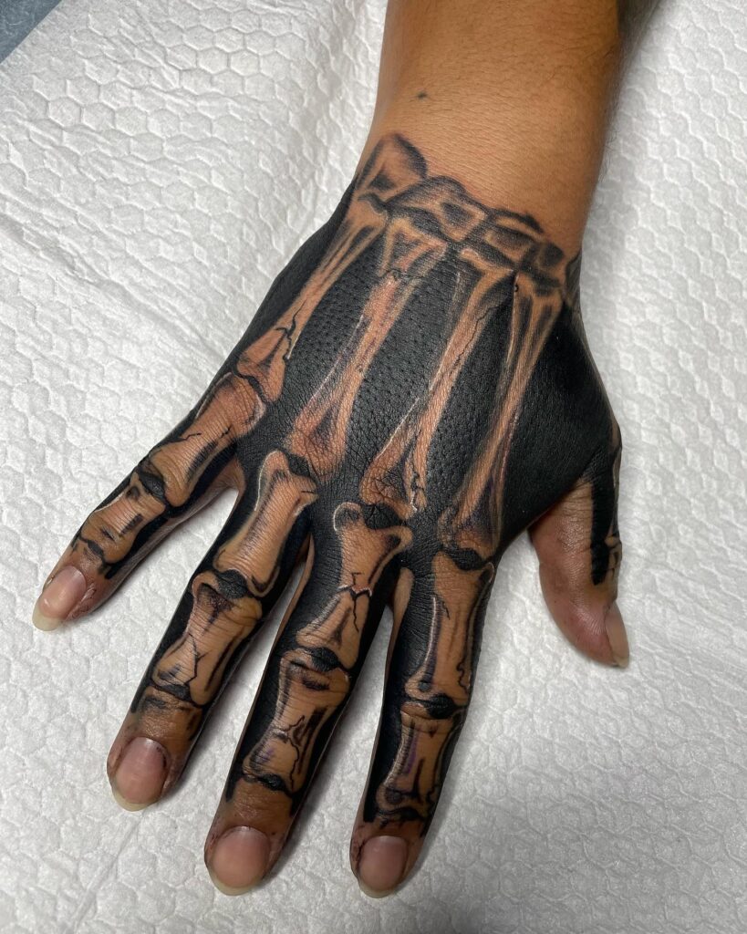 Black Colored Skeleton Hand Tattoo