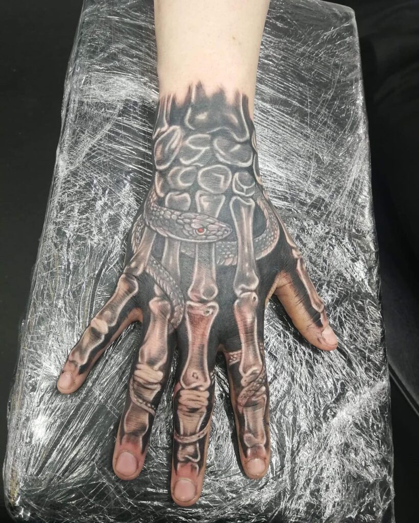 Fully Black Skeleton Hand Tattoo