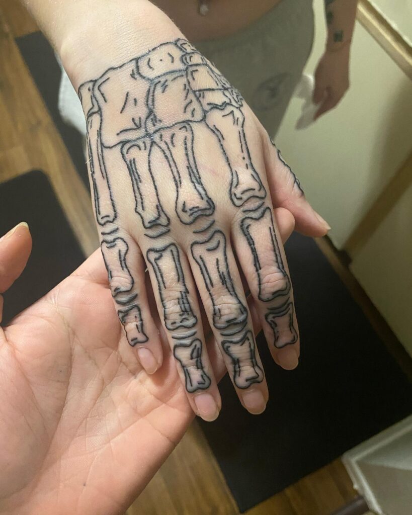 fine line skeleton hand tattoo
