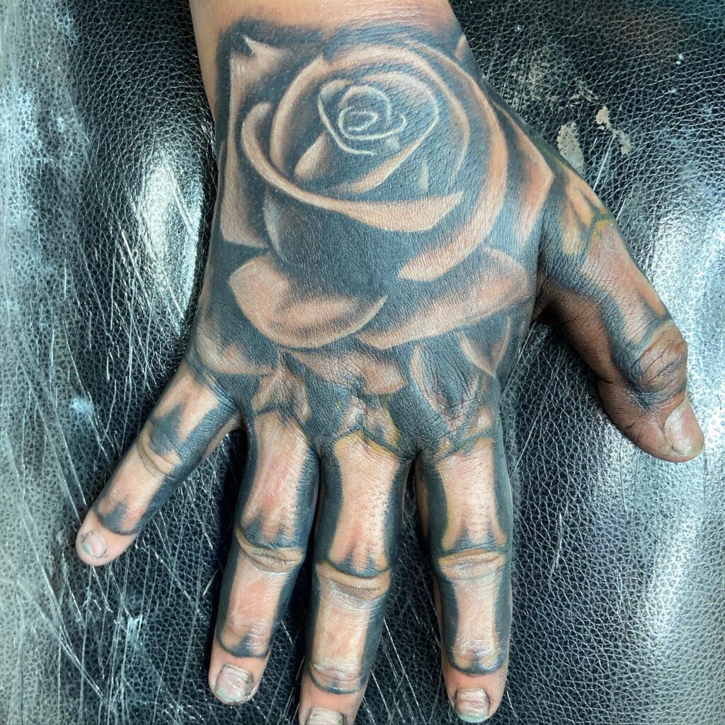 rose and skeleton hand tattoo