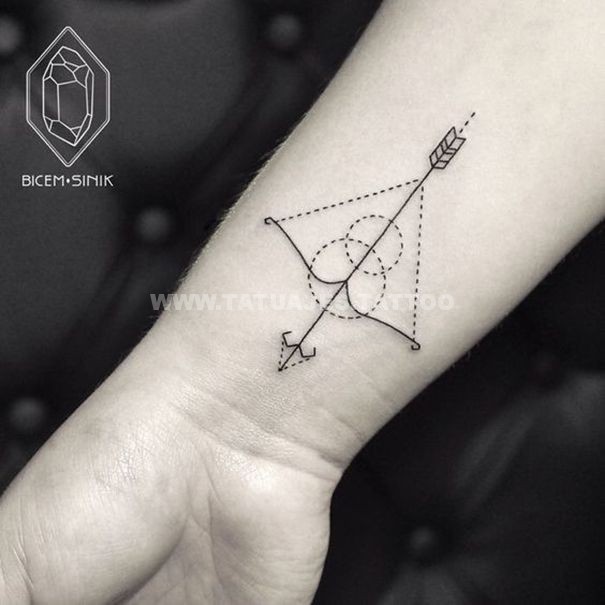 Minimalistic Sagittarius tattoo on wrist