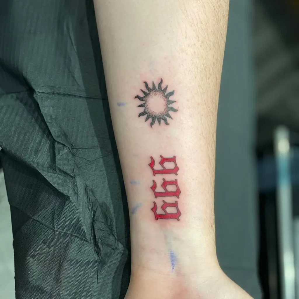 red 999 tattoo on arm