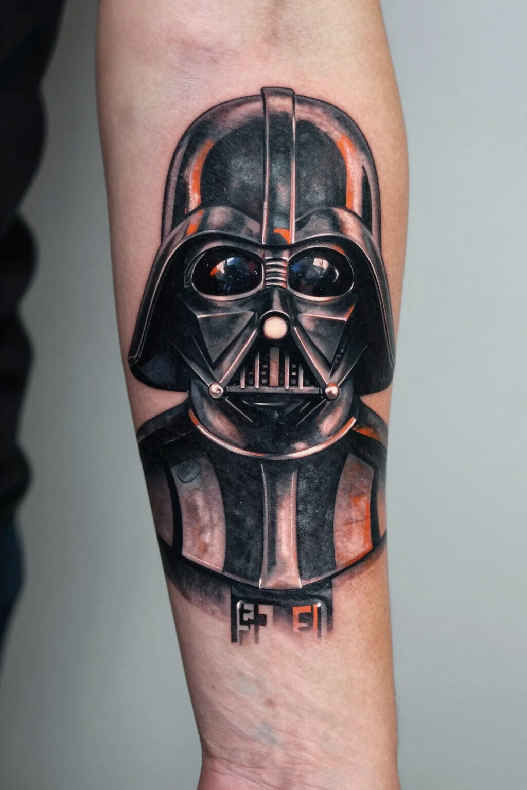 Realistic tattoo of Darth Vader's helmet on a forearm.