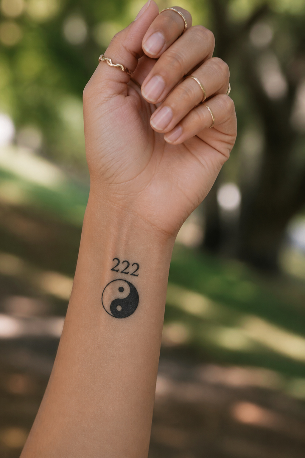 17 222 Tattoo Ideas and Meanings for 2026 14 A tattoo featuring the yin yang symbol alongside the numerals '222'.