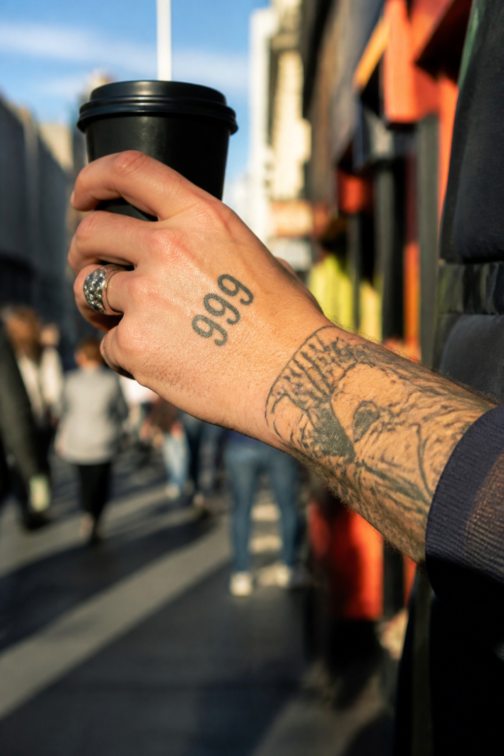 A 999 tattoo displayed on the back of a person's hand.