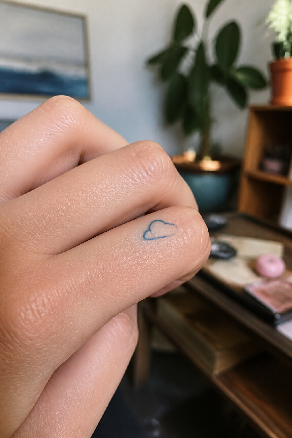 40 Cloud Tattoo Ideas for 2026: Japanese, Storm, Sleeve & More 18 Small outline tattoo of a cloud on a finger.