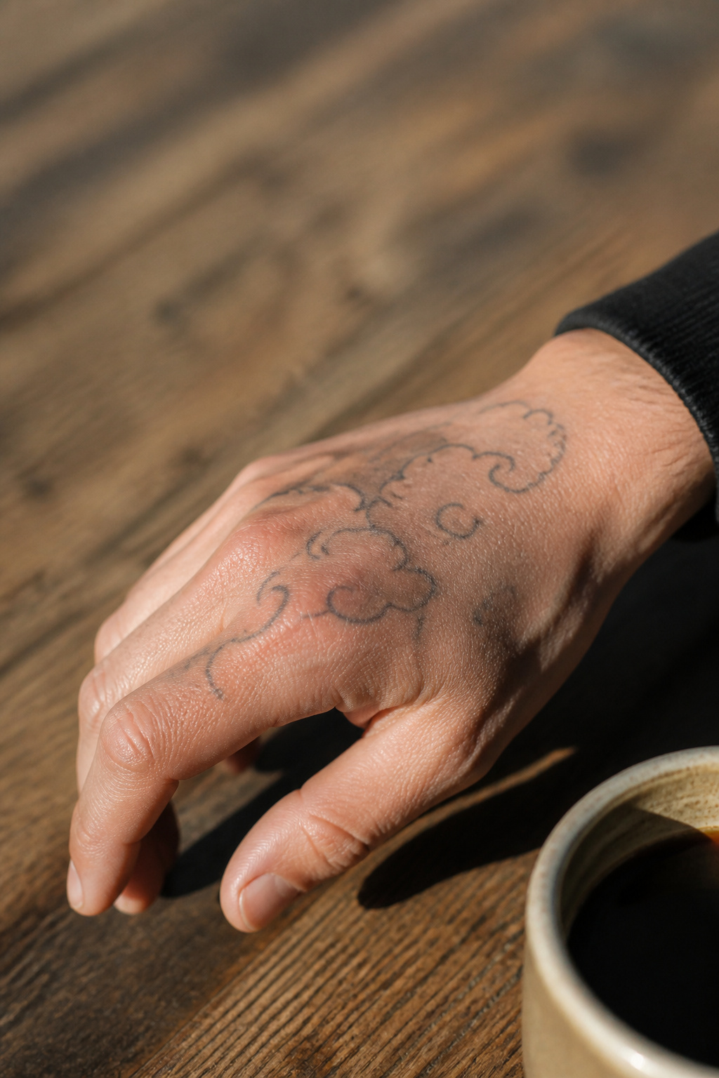 40 Cloud Tattoo Ideas for 2026: Japanese, Storm, Sleeve & More 19 Tattoo of clouds on the back of a hand.