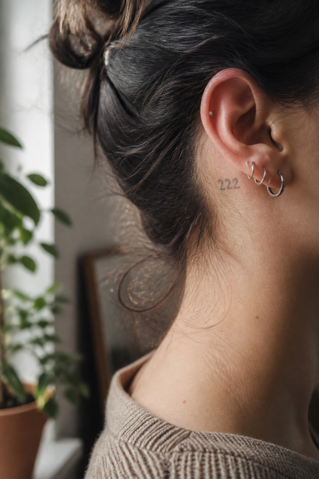 17 222 Tattoo Ideas and Meanings for 2026 2 Side profile showing a '222' tattoo inked behind the ear.