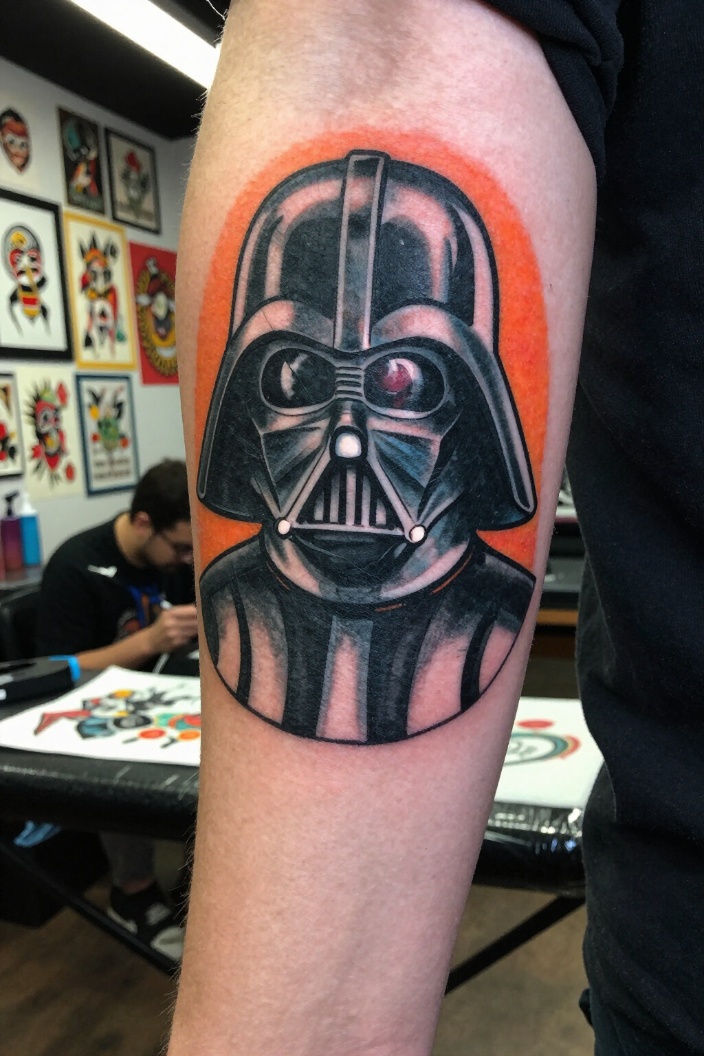 Traditional tattoo of Darth Vader's helmet with orange background.