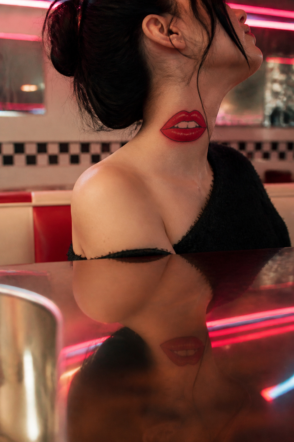 Lips Tattoo on Neck: 8 Design Ideas for 2026 4 A bold tattoo of red lips inspired by The Rocky Horror Picture Show.