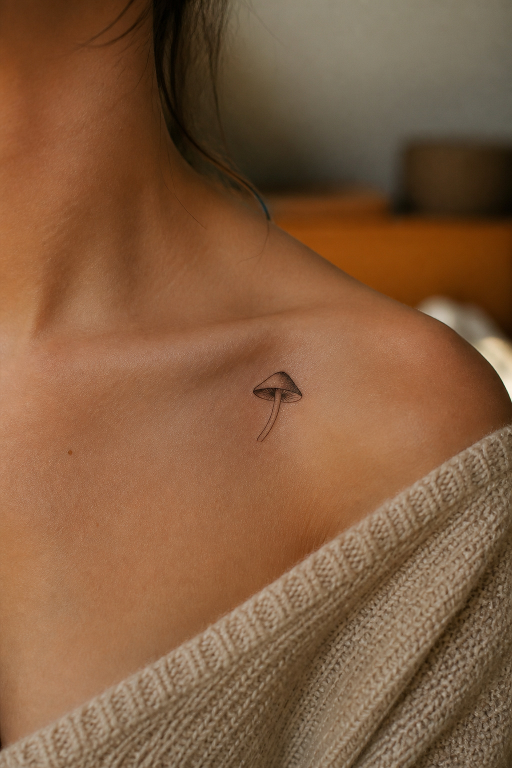 Minimalist mushroom tattoo with a shaded cap.