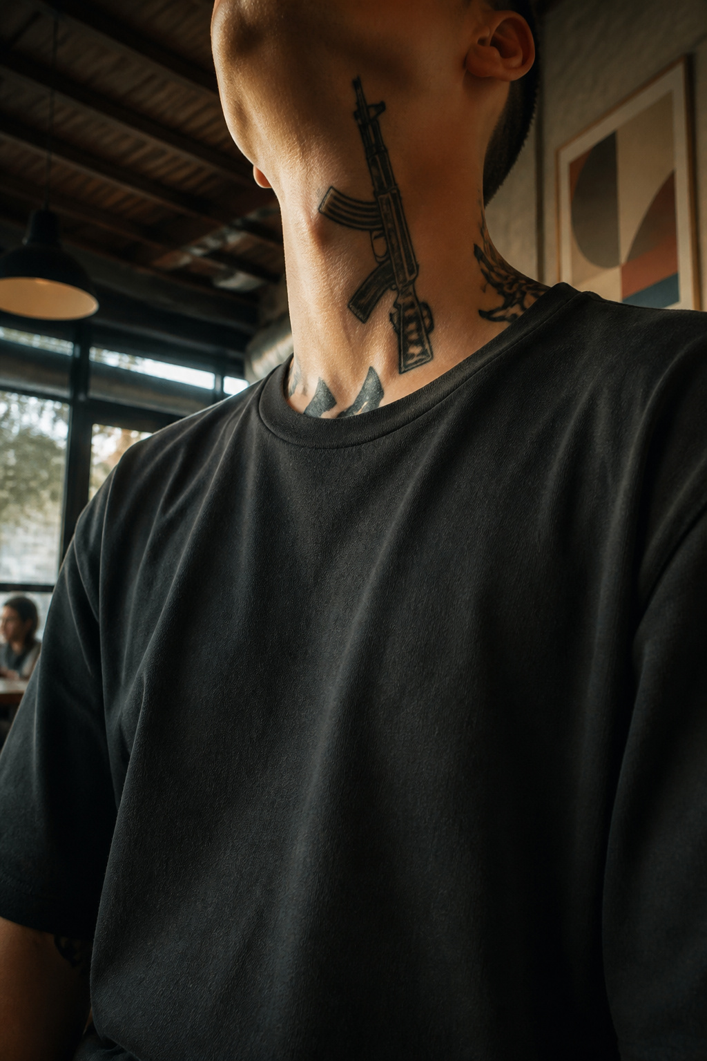 AK-47 tattoo prominently placed on a neck.