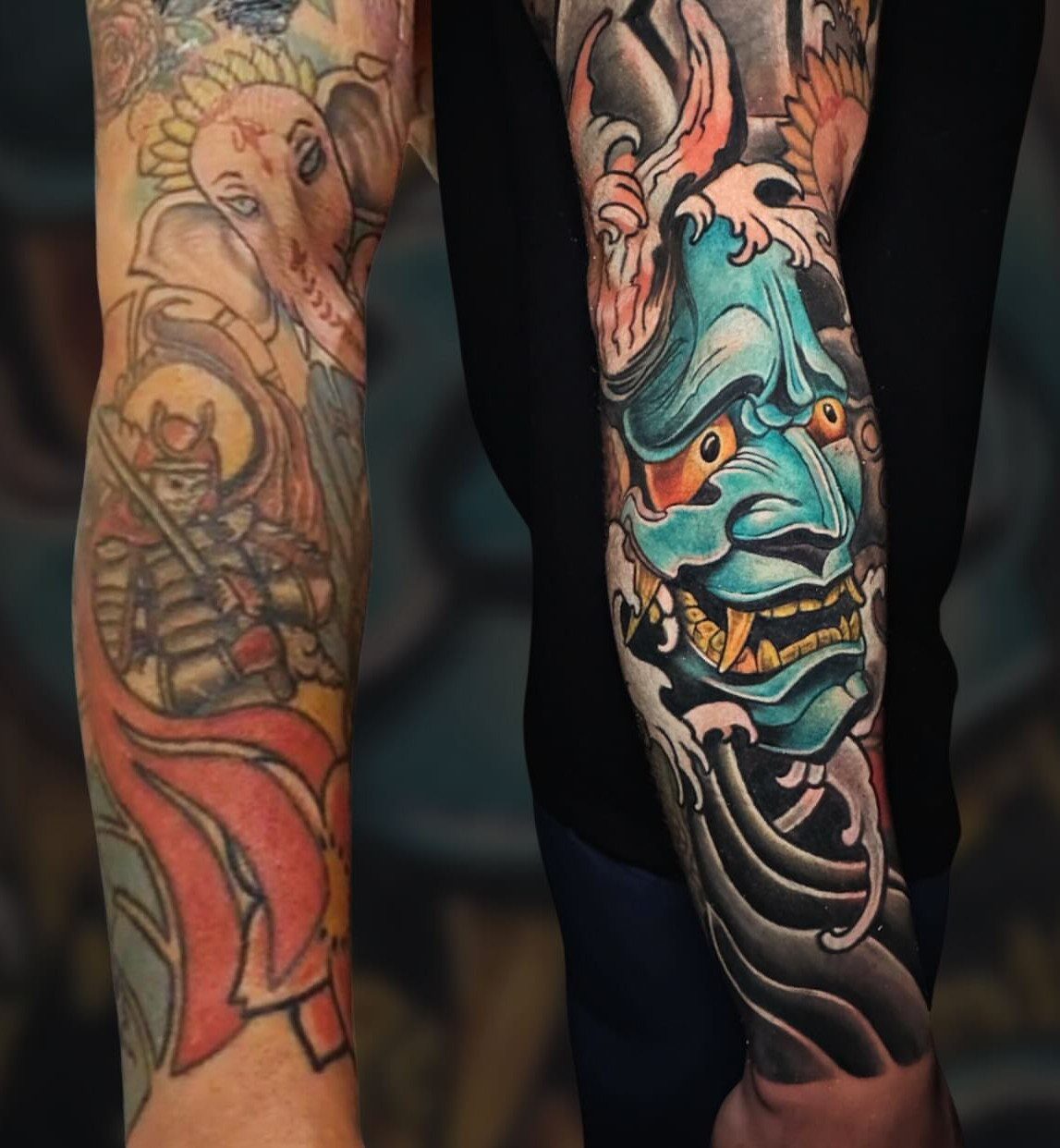 Two arms displaying large, colorful Japanese-style tattoos including a Ganesha and a blue Hannya mask.