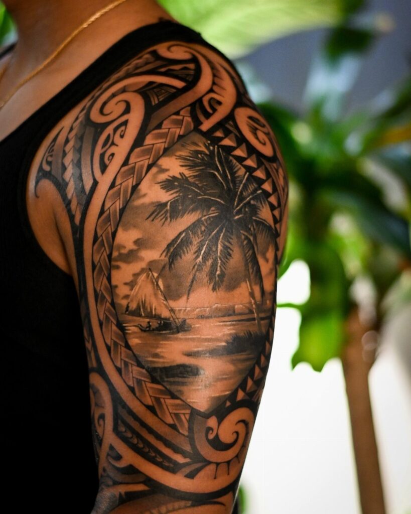 A detailed black ink tribal tattoo on a person's shoulder featuring a tropical landscape scene.