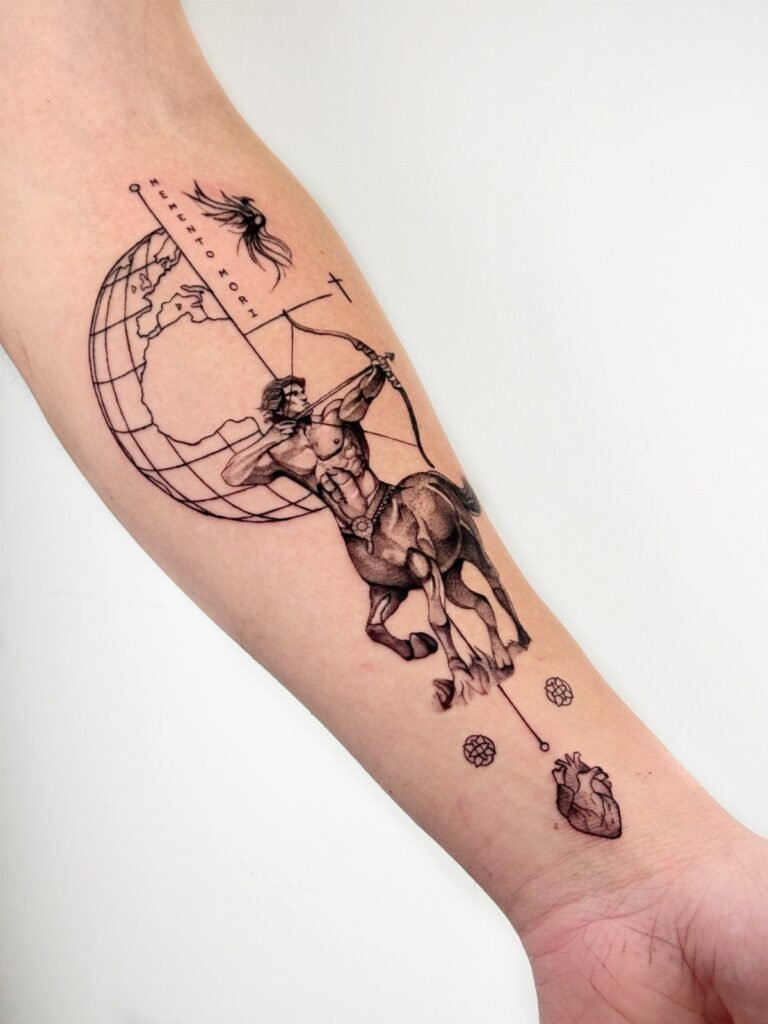 A detailed black ink centaur archer tattoo on a person's forearm with a globe and heart.