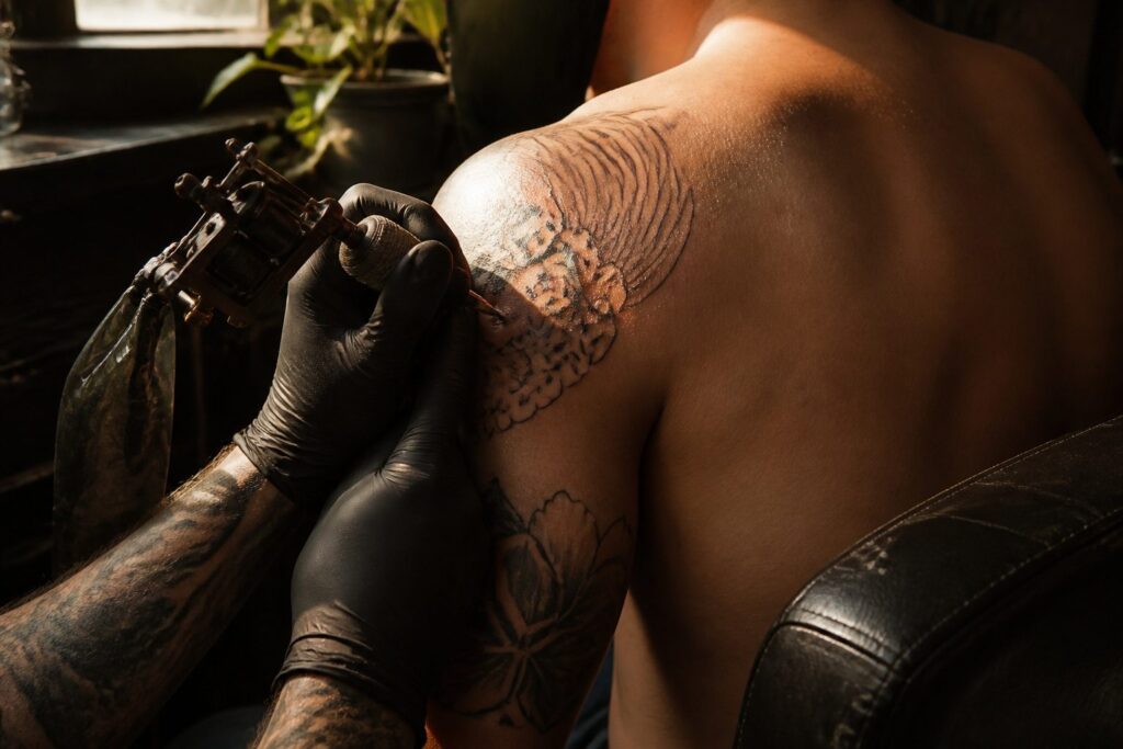 Multiple tattoos of various sizes on different skin areas.